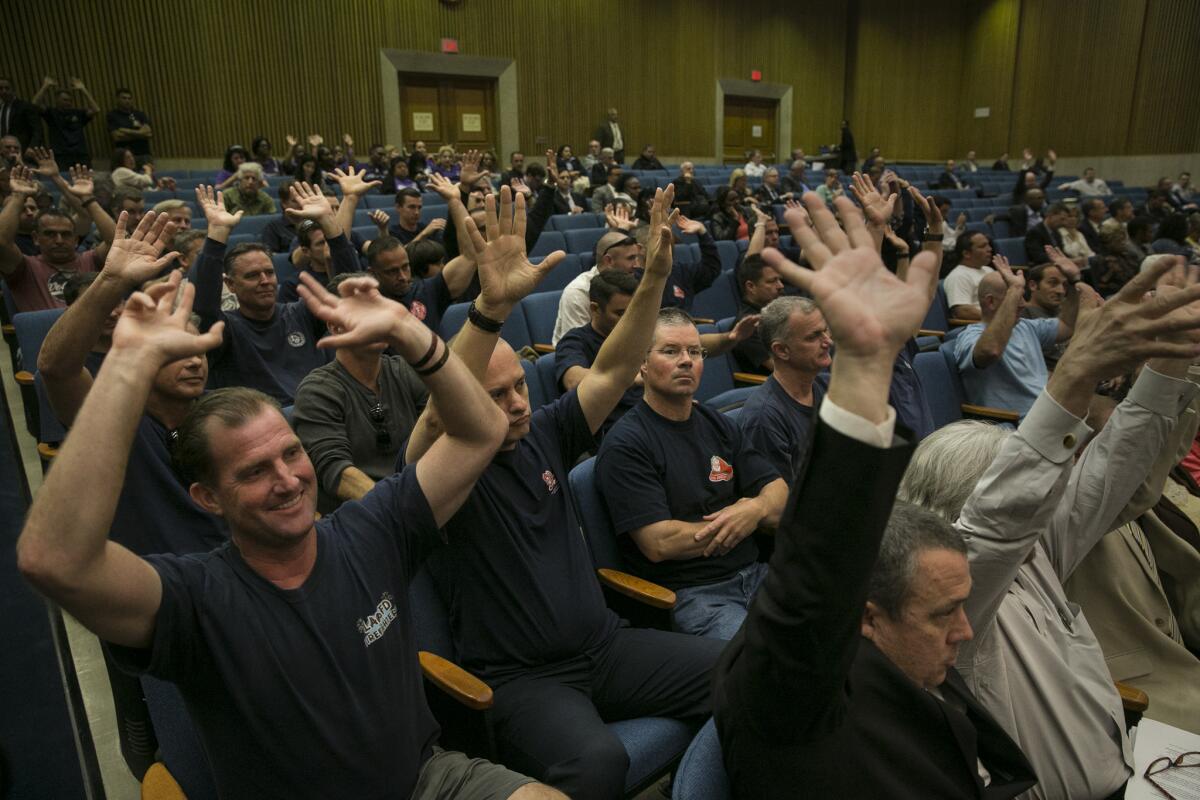 Los Angeles County firefighers express their concerns about cell towers at fire stations during a meeting of the Board of Supervisors.
