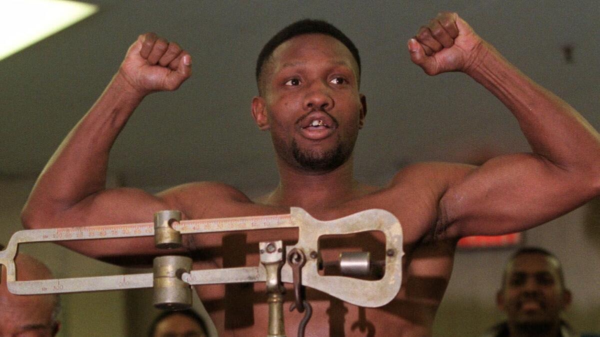 Pernell Whitaker flexes his muscles Feb. 19, 1999, during the weigh-in for his fight against Felix Trinidad in New York. Whitaker died Sunday night at age 55.