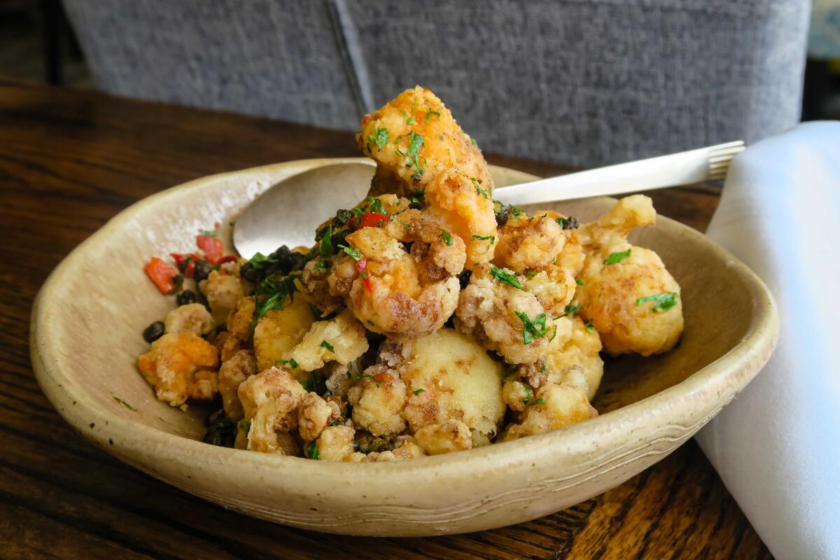 A bowl of flash-fried cauliflower, with capers, garlic, red chilies and anchovies, from Esther's Kitchen in Las Vegas.