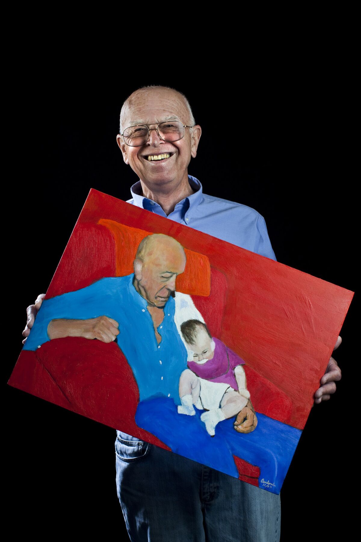 Joe Coulombe with a self-painted portrait of himself and granddaughter Julia.