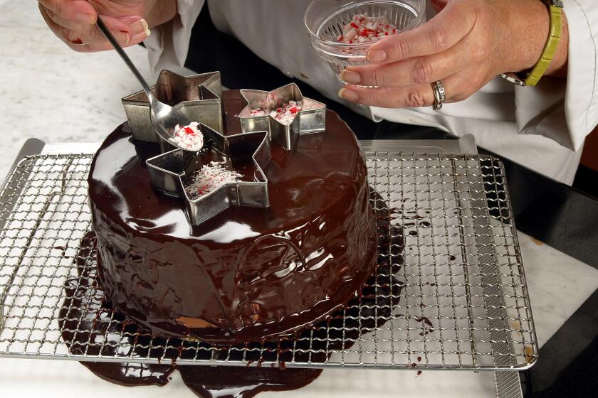 Digital Image taken on Friday, 12/10/2004, Los Angeles, CA - Photo by Ricardo DeAratanha/Los Angeles Times -- Chocolate cake with peppermint ganache. Making peppermint stars on cake.