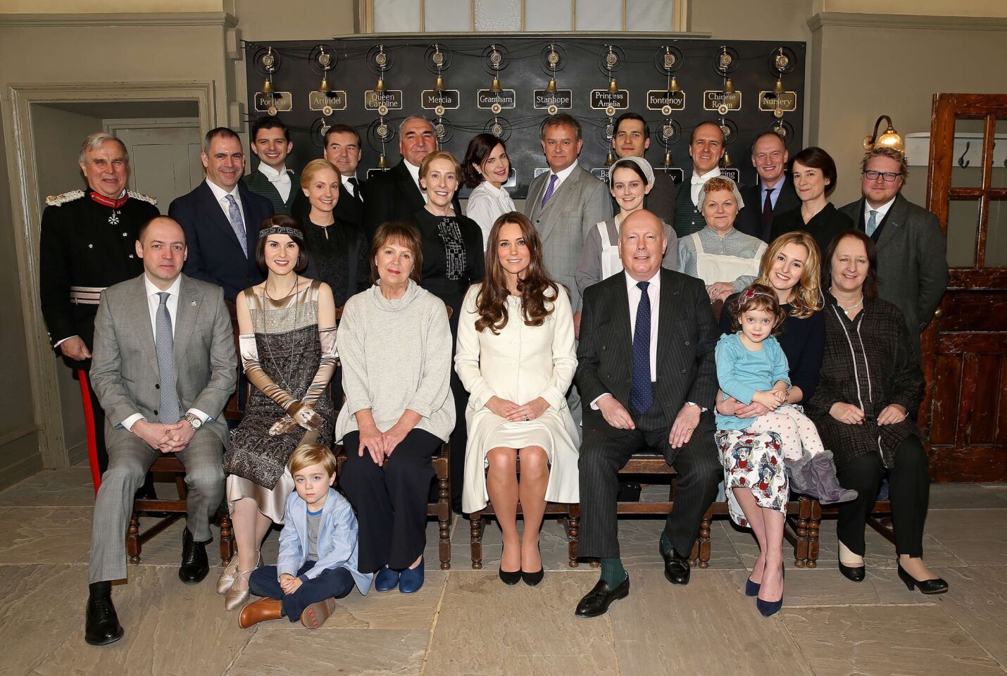 Britain's Catherine, Duchess of Cambridge (front, fifth from right), poses with the cast, crew and producers of British television series "Downton Abbey" during an official visit to the set at Ealing Studios in west London on March 12, 2015.