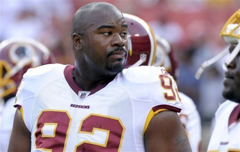 FILE - In this Aug. 21, 2010, file photo, Washington Redskins defensive lineman Albert Haynesworth looks on before an NFL preseason football game against Baltimore Ravens in Landover, Md. People with knowledge of the negotiations say that the Washington Redskins and the Tennessee Titans are in discussions about a trade of disgruntled defensive tackle Albert Haynesworth. The people spoke to The Associated Press on Tuesday, Sept. 7, 2010, on condition of anonymity because the talks are confidential. Washington signed Haynesworth to a $100 million contract in 2009 as a free agent, and the tackle accepted a $21 million bonus in April. (AP Photo/Susan Walsh, File)
