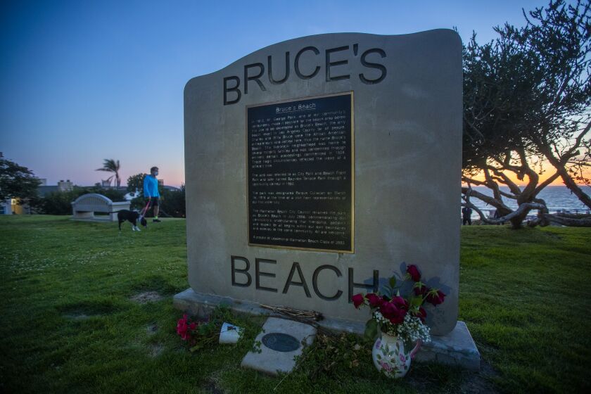 Manhattan Beach, CA - March 24: Los Angeles County is trying to give the land back to the Bruce family, a Black family that was pushed off Bruce's Beach a century ago by Manhattan Beach. Bruce's Beach was one of the most prominent Black-owned resorts by the sea.The Bruce family used to have a resort right on the strand where the Los Angeles County Lifeguard Division office is and was popular with Black beachgoers. The Bruce's Beach plaque is at the top of the hill, but the actual Bruce property is the lifeguard building at the bottom of the hill, on the Strand at Bruce's Beach on Wednesday, March 24, 2021 in Manhattan Beach, CA. (Allen J. Schaben / Los Angeles Times)