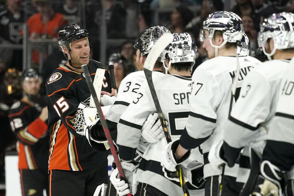 Ducks center Ryan Getzlaf (15), who is retiring after this season, is greeted by members of the Kings after the Kings' win.