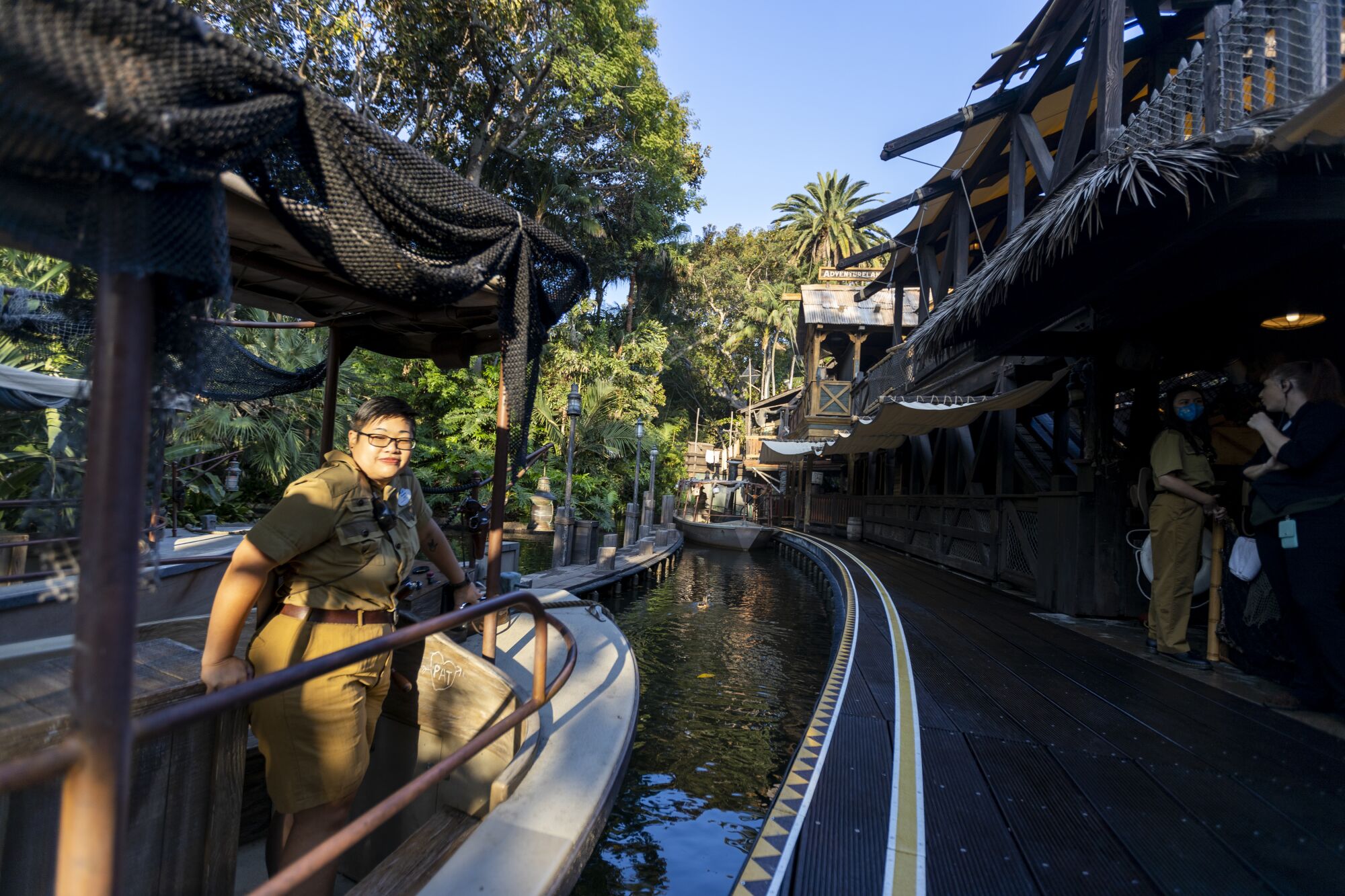 Skipper Amanda Beth Lorenzo stands in the Jungle Cruise boat at the entrance to the ride