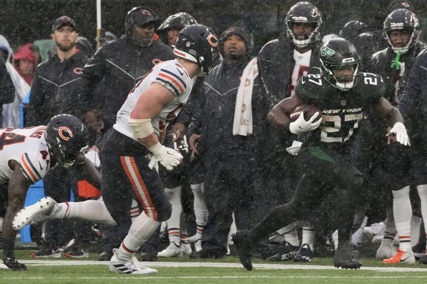New York Jets running back Zonovan Knight (27) carries the ball against the Chicago Bears during the third quarter of an NFL football game, Sunday, Nov. 27, 2022, in East Rutherford, N.J. (AP Photo/John Minchillo)