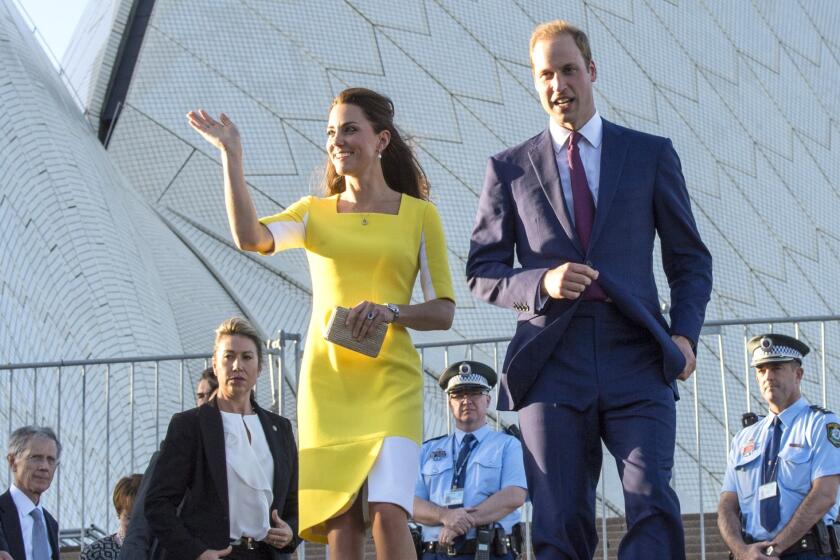 Prince William, Duke of Cambridge and Catherine, Duchess of Cambridge walk near the Sydney Opera House.