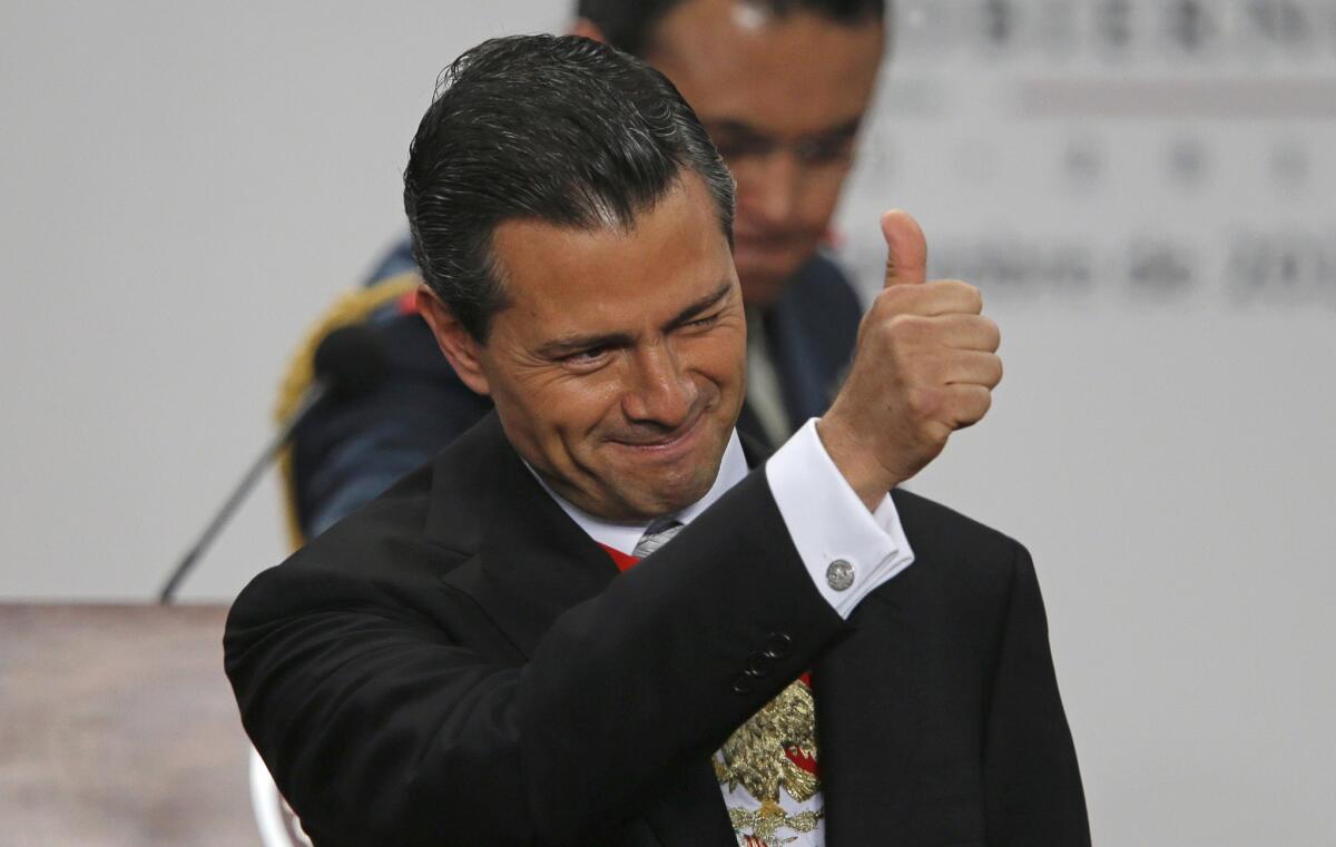 Mexico's President Enrique Pena Nieto gives a thumbs up as he gives his first state-of-the-nation address at Los Pinos presidential residence in Mexico City on Monday.