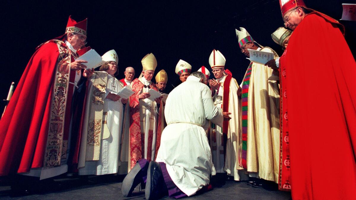 The Rev. J. Jon Bruno kneels before the Rt. Rev. Frederick Borsch, then bishop of the Episcopal Diocese of Los Angeles.