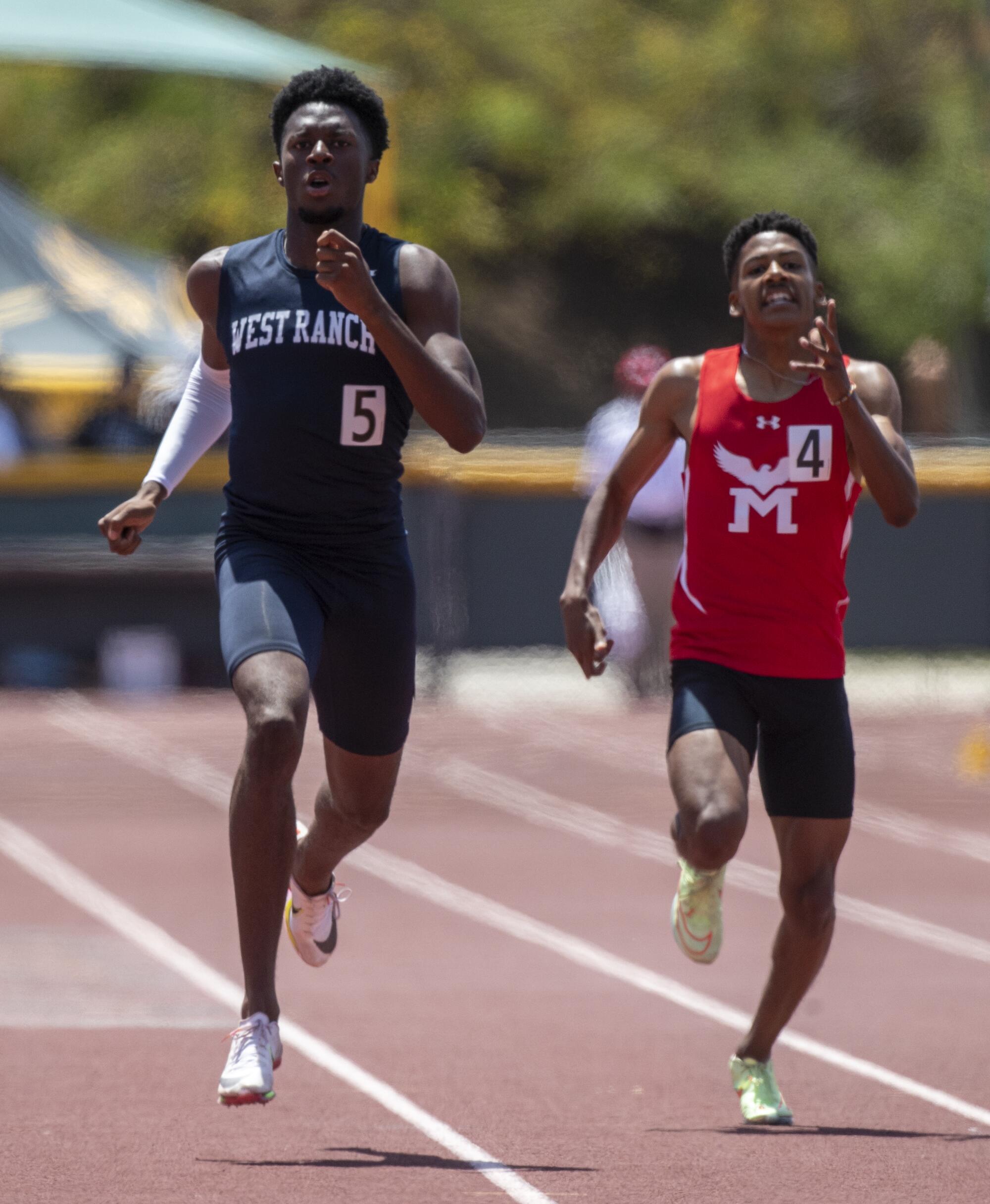 West Ranch's Chris Goode, left, wins the boys' 400 meters at the Masters Meet.
