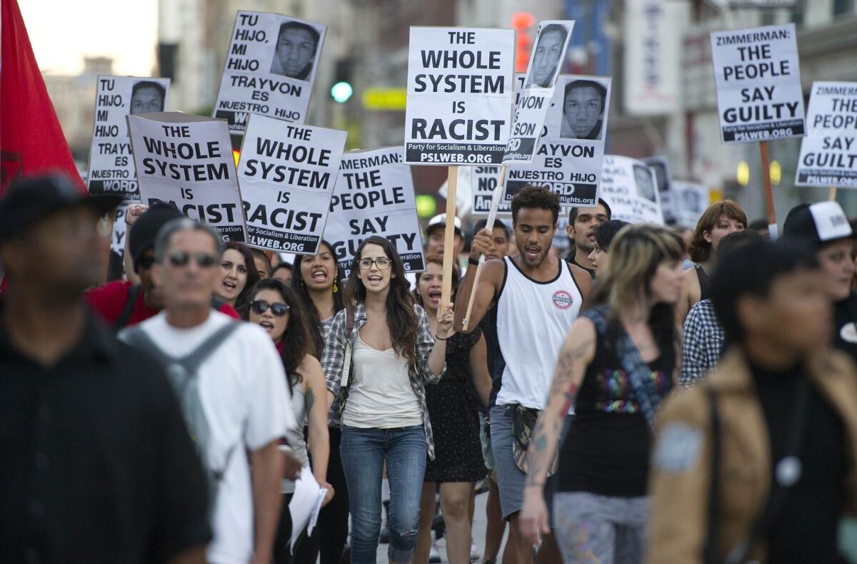 Protesters march through downtown Los Angeles to show their disapproval of George Zimmerman's acquittal on murder charges in the death of Florida teen Trayvon Martin.