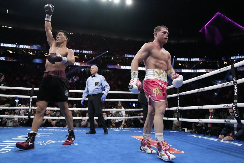 Dmitry Bivol, left, of Kyrgyzstan, and Canelo Alvarez, of Mexico, react after their light heavyweight title boxing match, Saturday, May 7, 2022, in Las Vegas. (AP Photo/John Locher)