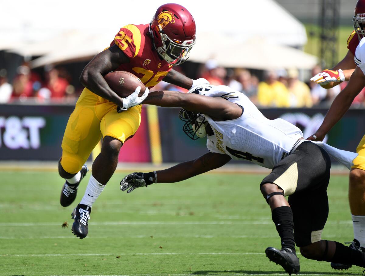 USC running back Ronald Jones II eludes the tackle of Western Michigan cornerback Darius Phillips during the first quarter of their game.