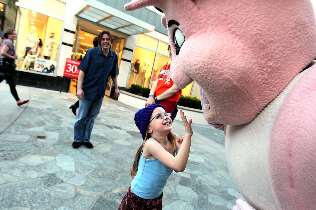 Alexis Zellman, 5, greets a giant shrimp, right, as her father, Jason Zellman, looks on at Anaheim GardenWalk, where they had dined at Bubba Gump Shrimp Co. A four-diamond JW Marriott hotel is expected to be built at GardenWalk to take advantage of a city incentive program.