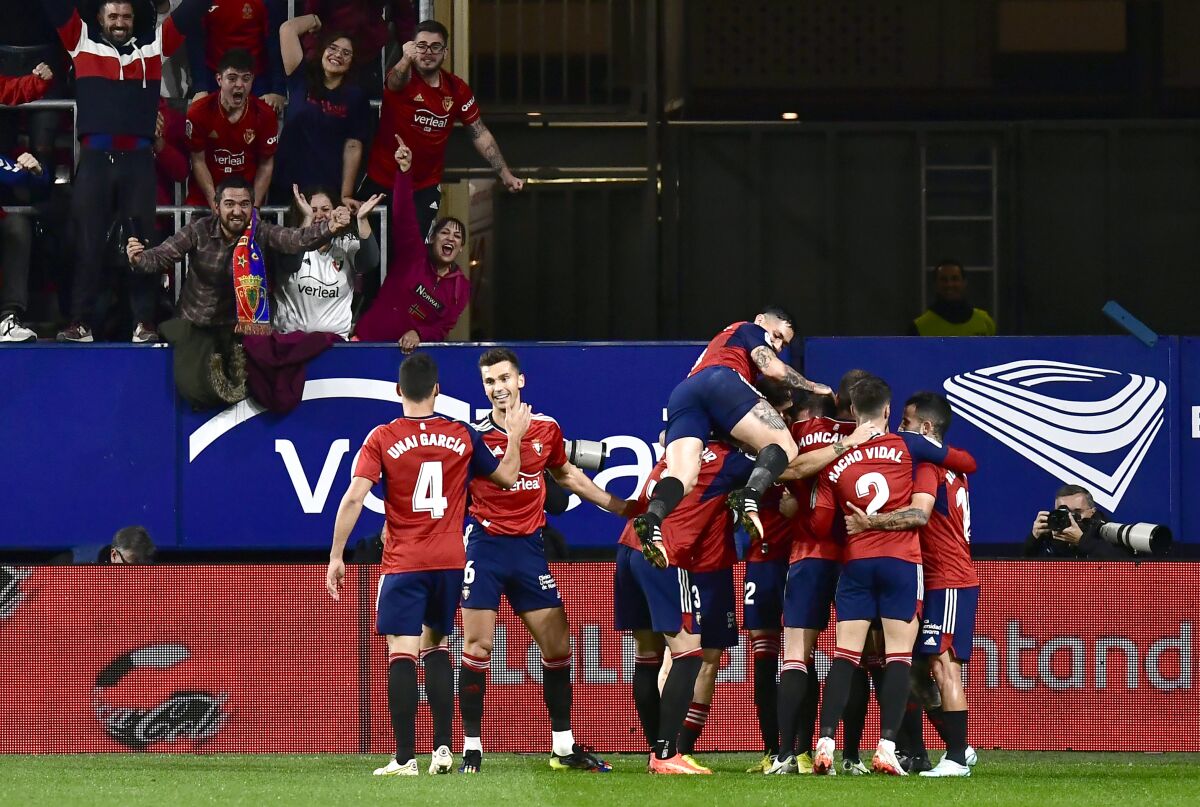 Osasuna players celebrate after David Garcia scored during a La Liga match against Barcelona
