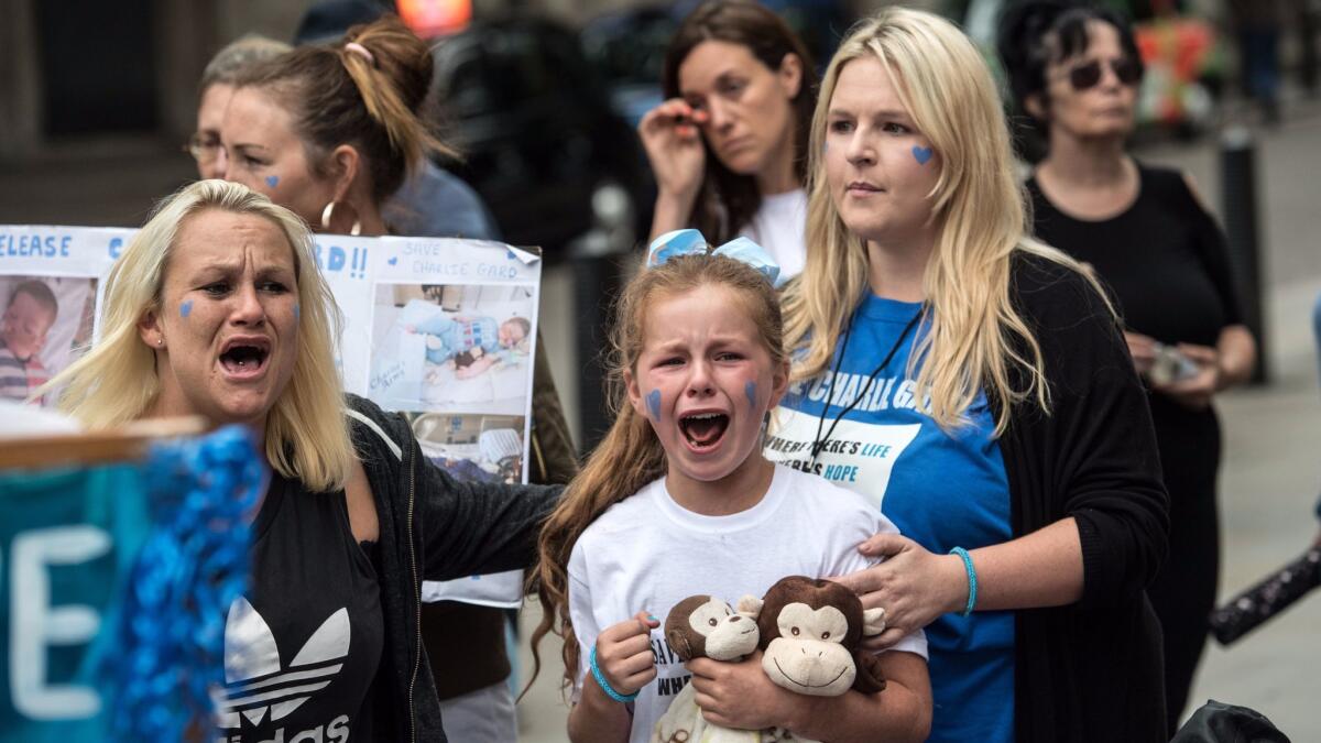 Demonstrators react to news that Charlie Gard's parents have withdrawn their application to bring the terminally ill baby to the United States because they believe it is too late for an experimental therapy to have any effect.