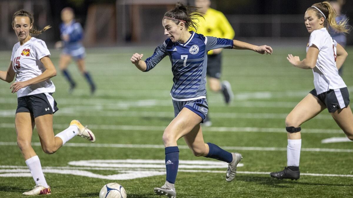 Newport Harbor striker Sadie Pitchess, center, shown playing against Mission Viejo on Feb. 6, shared the Wave League MVP award last season.