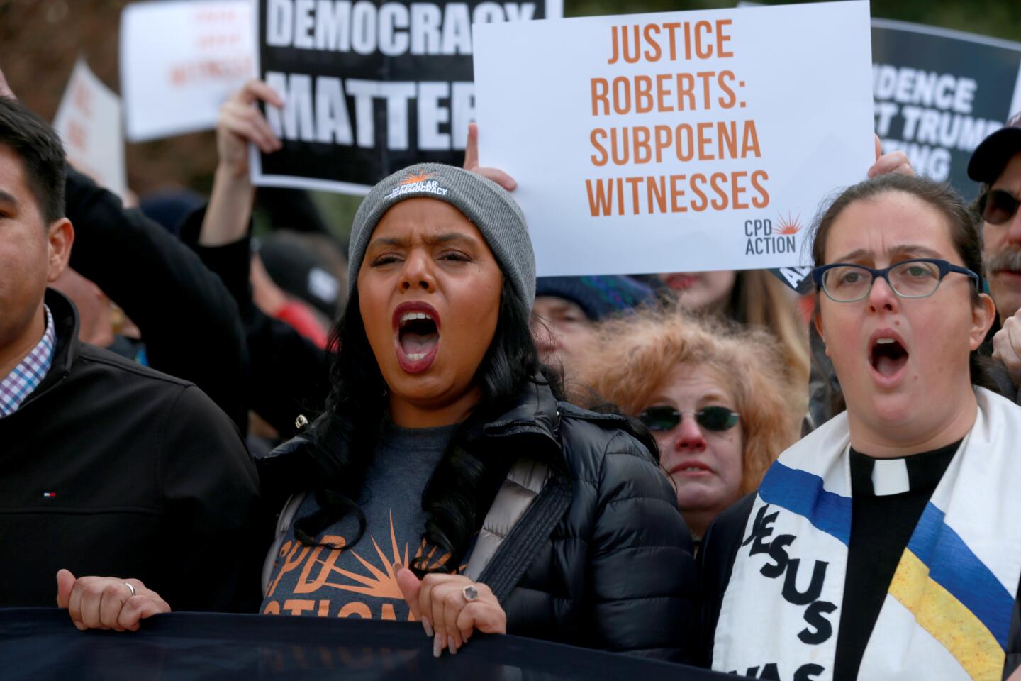 Demonstrators marched from the Hart Senate building to the Capitol during the start of Day 8 of the Senate impeachment trial of President Trump in Washington, D.C., on Wednesday.