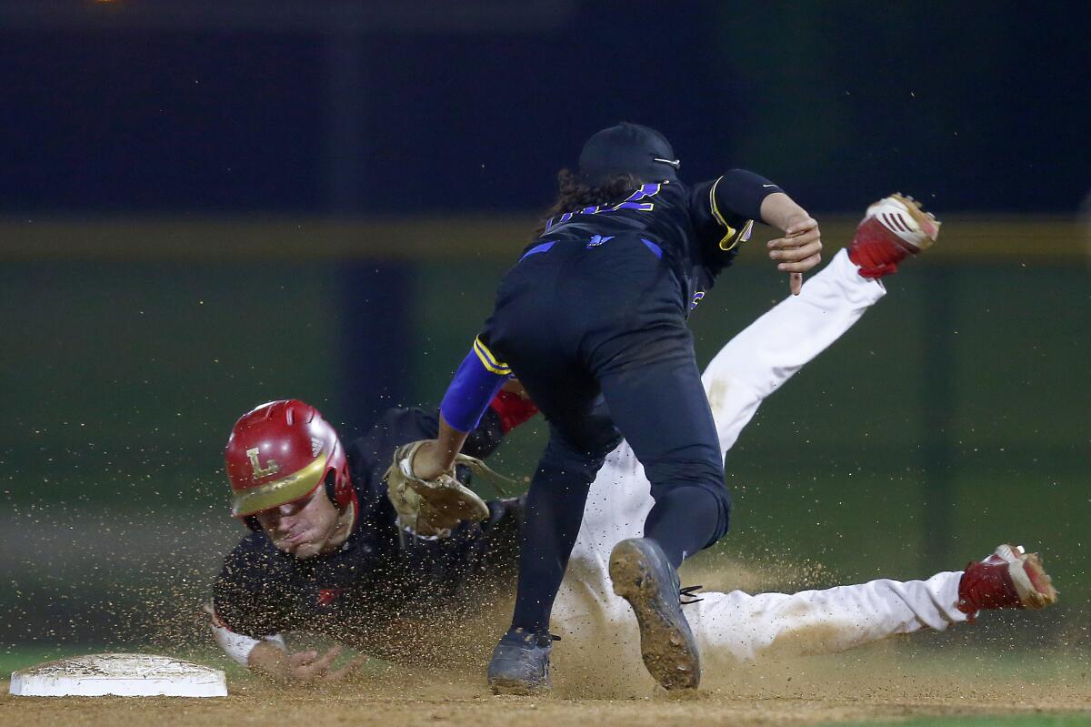 La Mirada shortstop Jimmy Blumberg catches Orange Lutheran infielder Tank Espalin trying to steal second base during a game at the Great Park in Irvine on Feb. 19, 2020.