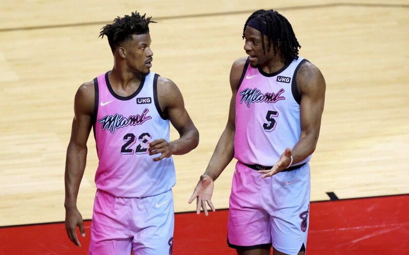 Miami Heat's Jimmy Butler, left, and Precious Achiuwa talk during the second quarter against the Houston Rockets in an NBA basketball game Thursday, Feb. 11, 2021, in Houston. (Carmen Mandato/Pool Photo via AP)