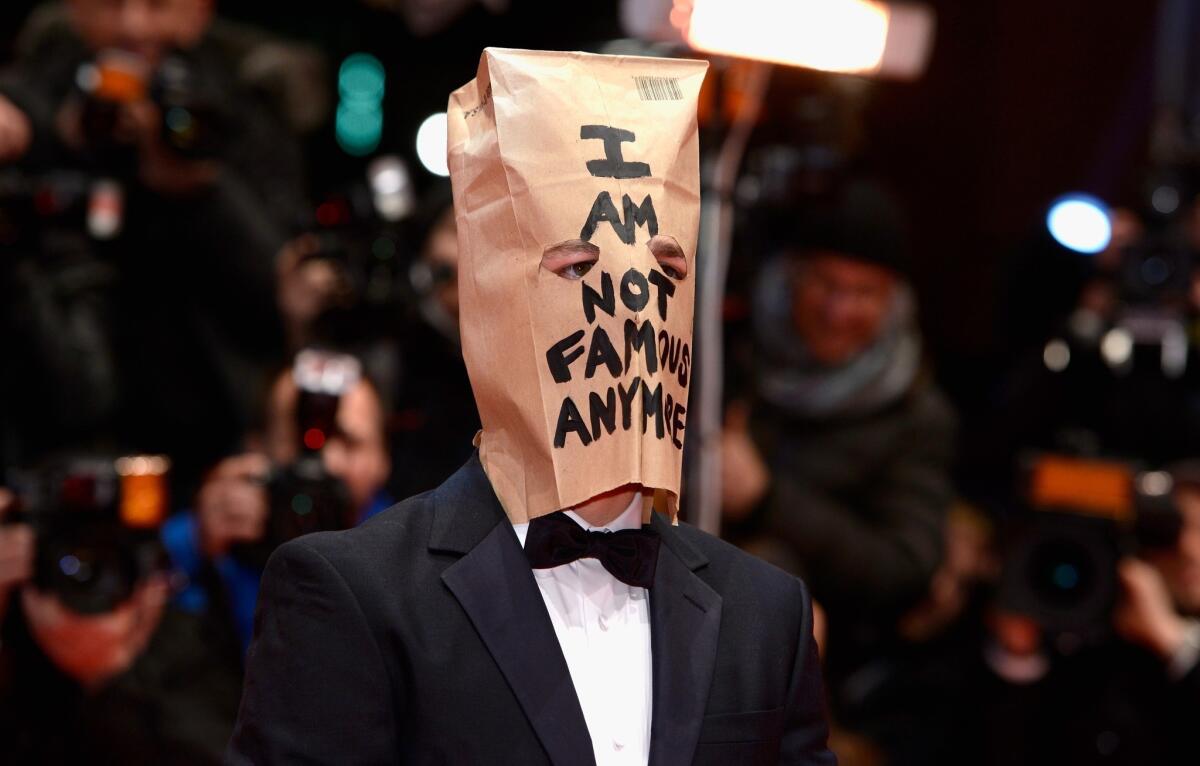 Shia LaBeouf attends the "Nymphomaniac" premiere at the 64th Berlin International Film Festival wearing a paper bag on his head.