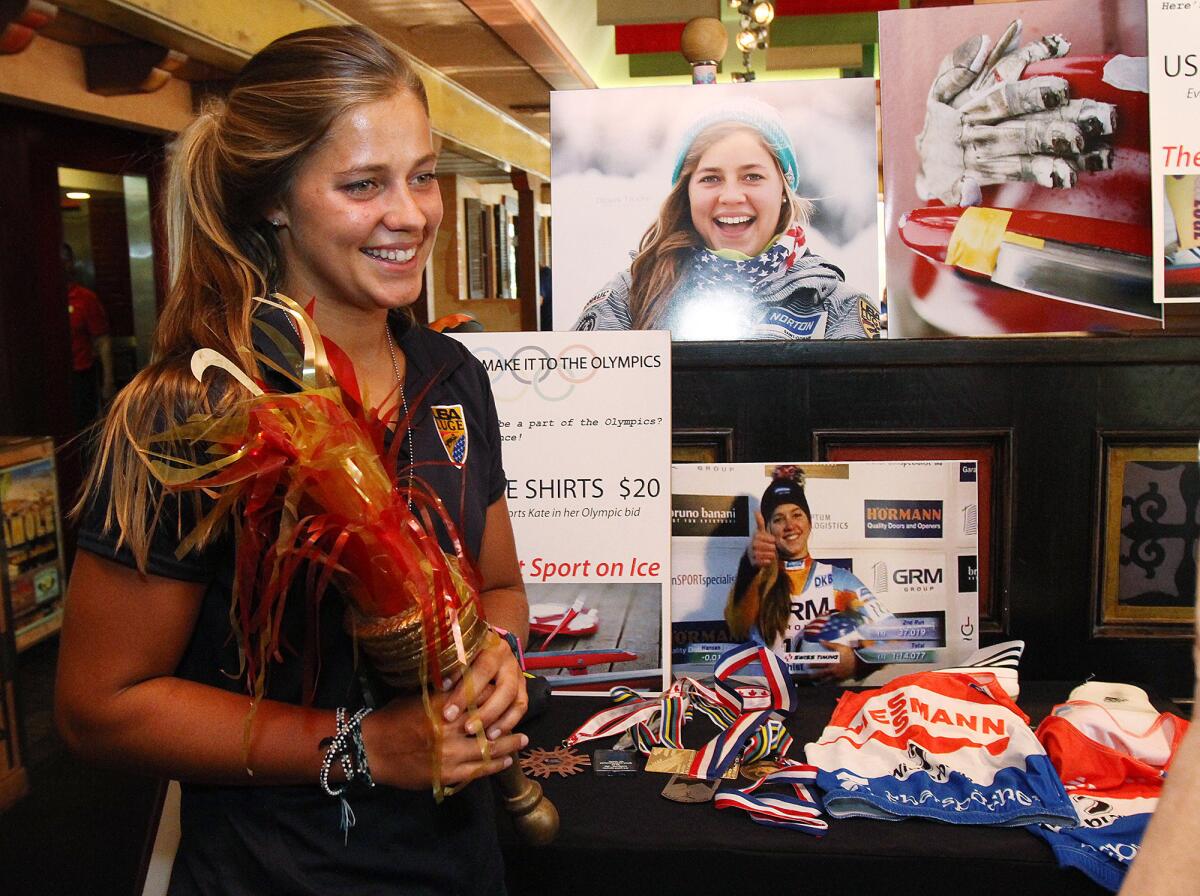 Kate Hansen, a graduate of La Cañada High School, holds an Olympic torch decoration from the 1984 Olympics for a photo at Los Gringos Locos for a fundraiser to help raise money for her to train with the U.S. Women's Olympic Luge Team on Thursday, August 29, 2013. The restaurant donated 15% of the night's tabs to her fundraiser fund.