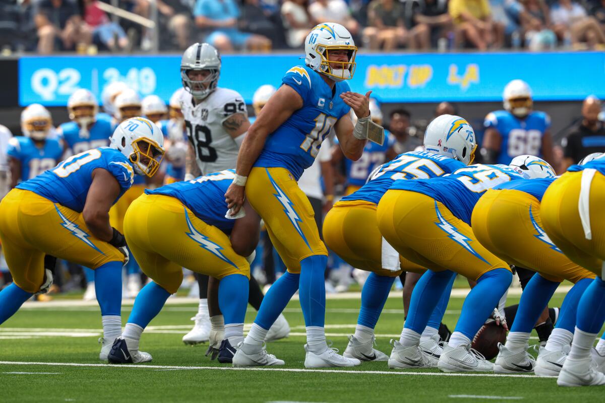 Chargers quarterback Justin Herbert (10) signals a play during a drive against the Raiders at SoFi Stadium. 