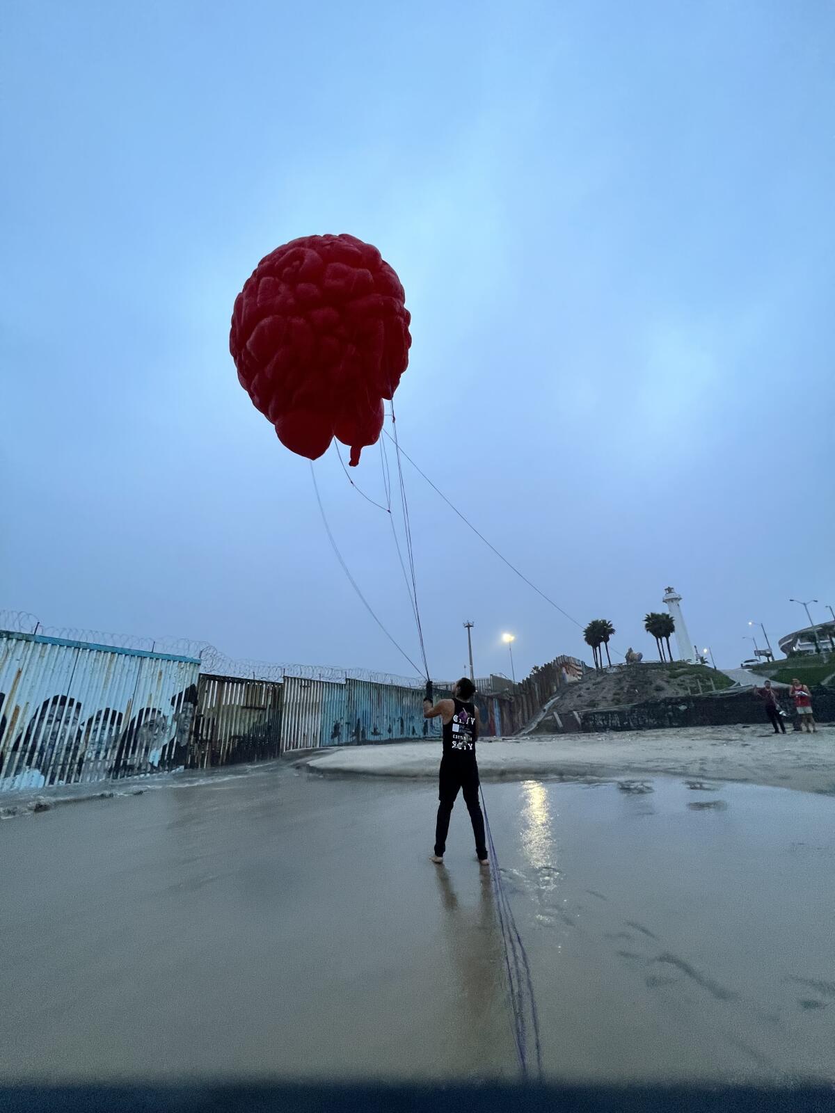 Alejandro Rocha, 36, flies the Aforo Nómada art piece in Playas de Tijuana on Sept. 9, 2022.