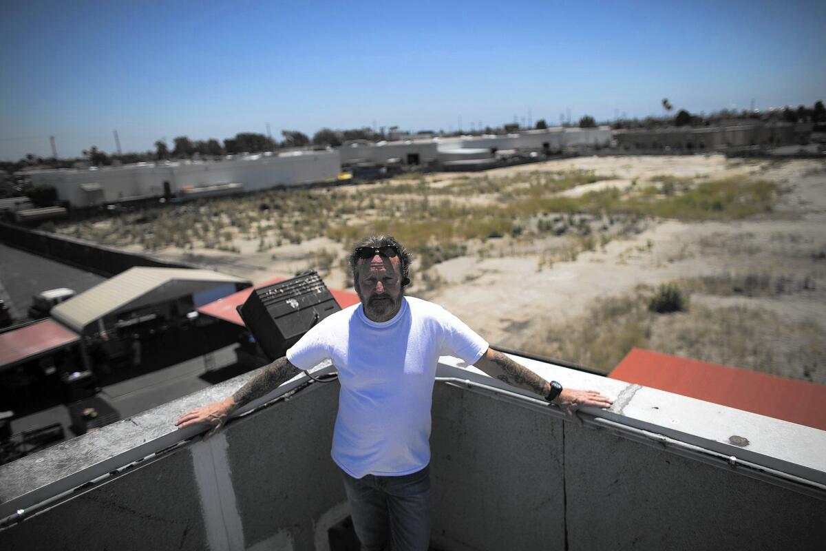 Robert Hardison, a manager at All Access Staging & Productions in Harbor Gateway, is opposed to a six-story apartment project slated to be built next to his firm's property.