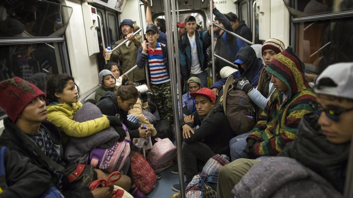 Central American migrants ride on the subway after leaving the temporary shelter at the Jesus Martin