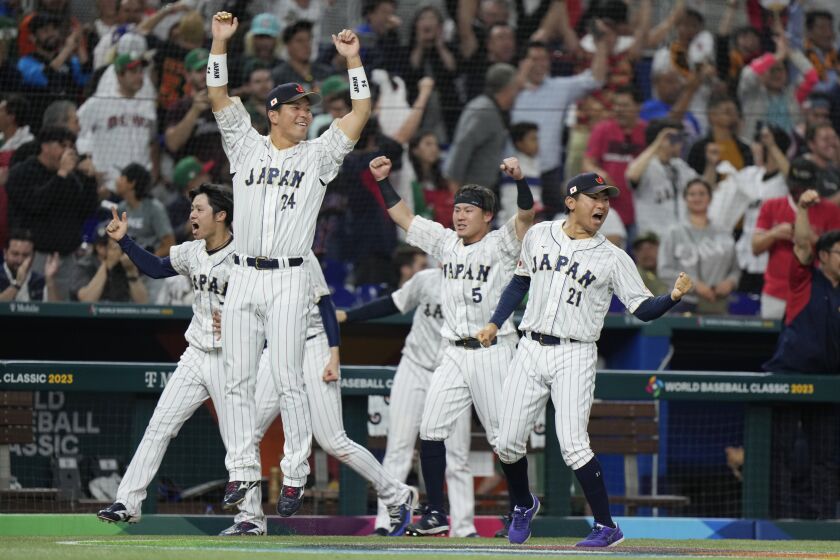 Japan players celebrate after Masataka Yoshida hit a home run scoring Kensuke Kondoh and Shohei Ohtani during the seventh inning of a World Baseball Classic game against Mexico, Monday, March 20, 2023, in Miami. (AP Photo/Wilfredo Lee)