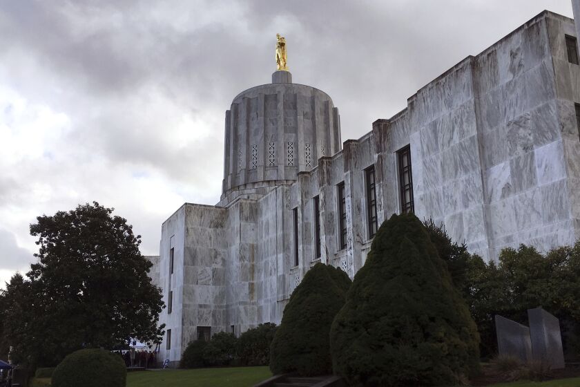 FILE - Clouds hover over the Oregon Capitol, Jan. 11, 2018, in Salem, Ore. Oregon Senate Democrats plan to start fining their absent colleagues amid a month-long Republican walkout, a move they hope will pressure boycotting lawmakers to return to the chamber as hundreds of bills languish amid the partisan stalemate. In a procedural move Thursday, June 1, 2023, Democrats voted to fine senators $325 every time their absence denies the chamber the two-thirds quorum it needs to conduct business. (AP Photo/Andrew Selsky, File)