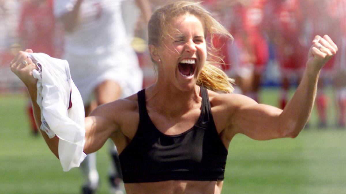 Brandi Chastain celebrates after scoring the winning shootout goal in the U.S. national team's triumph.