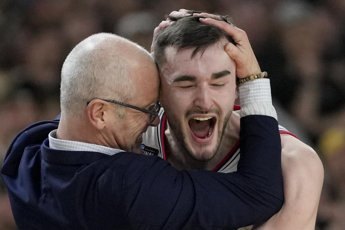 UConn coach Dan Hurley celebrates with forward Alex Karaban after their national title game win over Purdue 