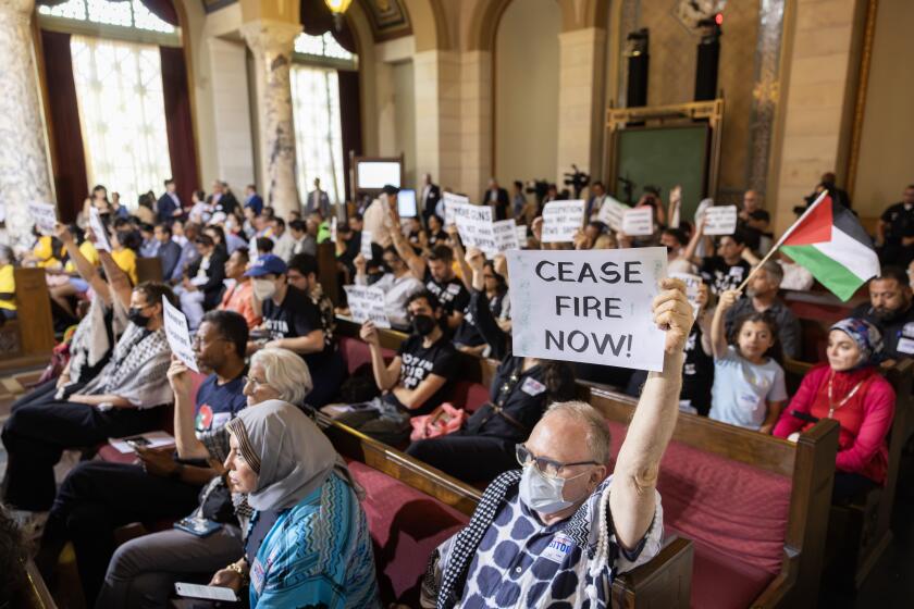 LOS ANGELES, CA - JULY 02: Groups against a proposed City Council resolution to fund Zionist defense training pack the council chamber as they spoke out against the motion on Tuesday, July 2, 2024 at City Hall in Los Angeles, CA. The motion would provide upwards of $1 million to Pro-Israel vigilante/security companies for Zionist defense training. (Myung J. Chun / Los Angeles Times)