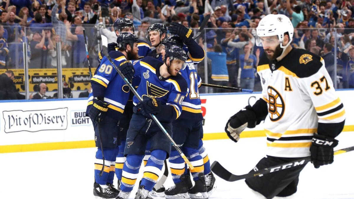 Brayden Schenn (10) of the St. Louis Blues celebrates his empty-net goal in the third period as Boston's Patrice Bergeron passes by in Game 4 of the Stanley Cup Final at Enterprise Center in St Louis, Mo.