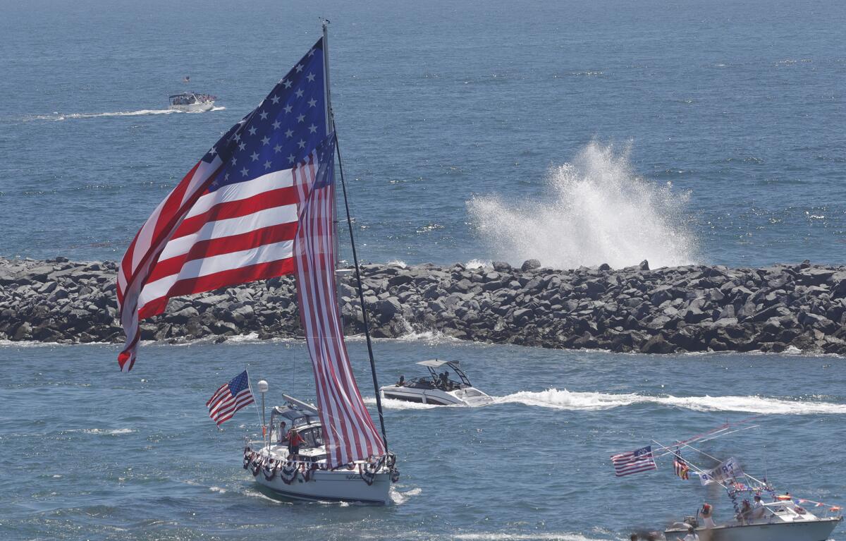  The Newport Harbor entrance on the 4th of July as huge waves crash at the Wedge.