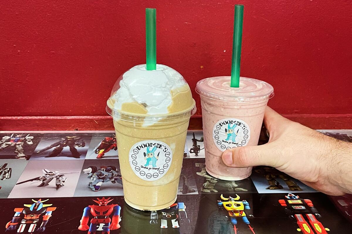 Two Doomie's vegan milkshakes: horchata coffee with coconut whipped cream, and strawberry. 