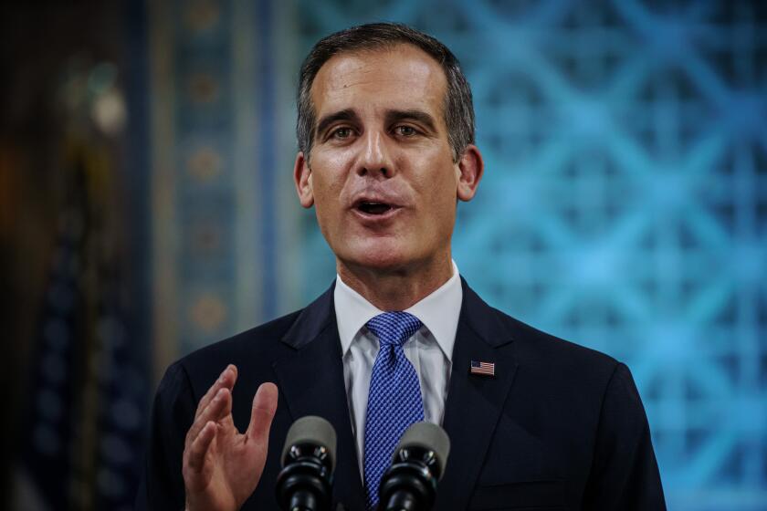 LOS ANGELES, CALIF. -- SUNDAY, APRIL 19, 2020: Los Angeles Mayor Eric Garcetti tears up as he gives his annual 'State of the City' speech at City Hall in Los Angeles, Calif., on April 19, 2020. (MANDATORY CREDIT: Pool photo by Marcus Yam / Los Angeles Times)