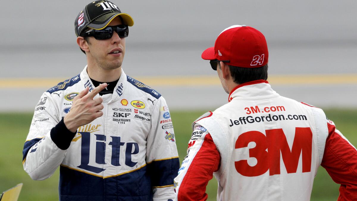 NASCAR drivers Brad Keselowski, left, and Jeff Gordon talk on the grid during qualifying at Talladega Superspeedway last weekend.