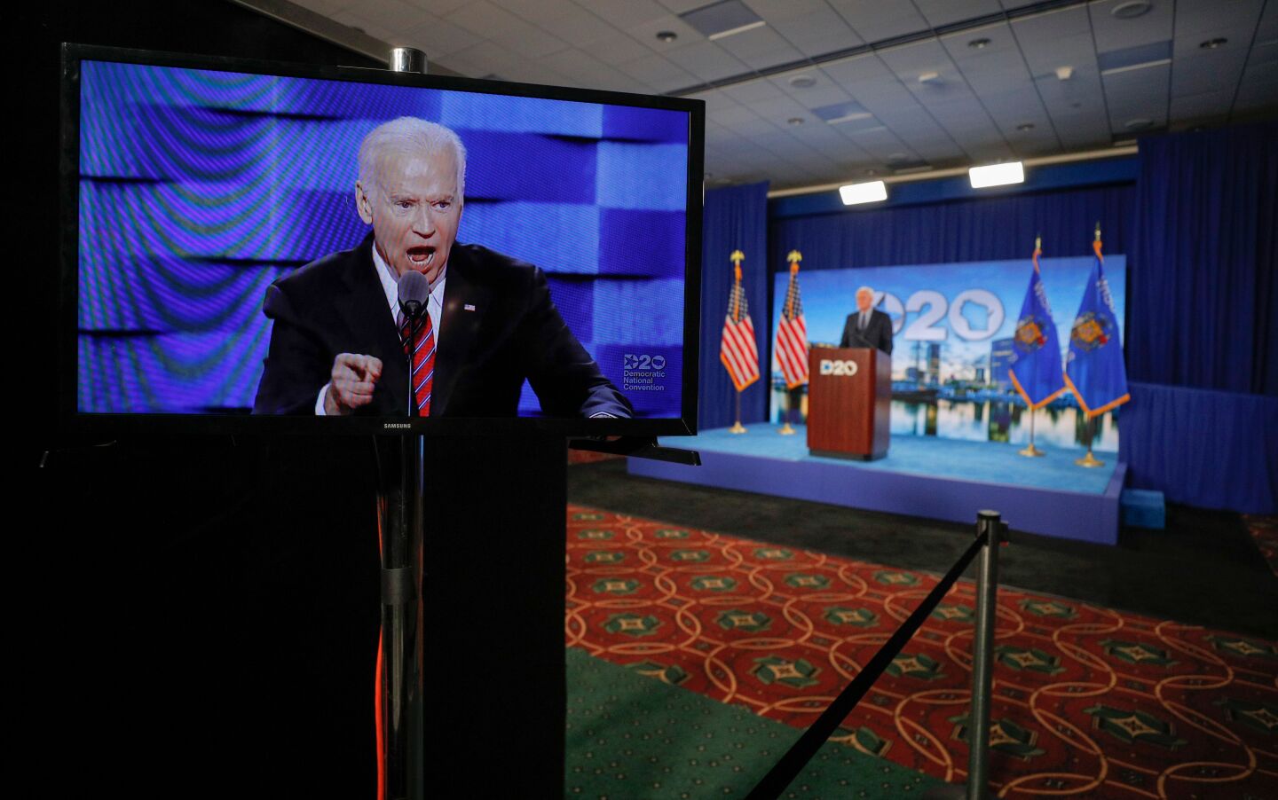 Joe Biden appears on a screen as Milwaukee Mayor Tom Barrett opens the second night of the Democratic National Convention.