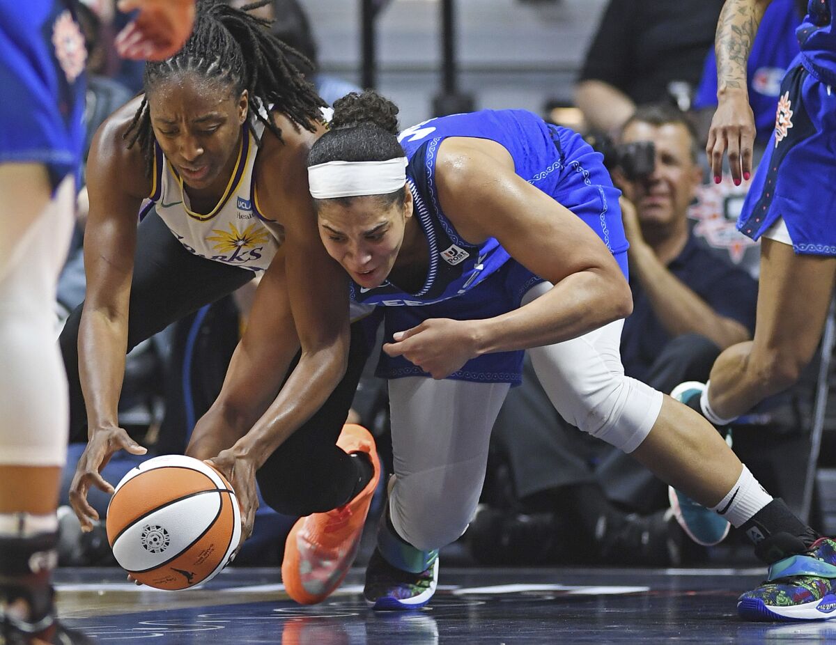 Connecticut Sun center Brionna Jones, right, battles Los Angeles Sparks forward Nneka Ogwumike, left, for the ball during a WNBA basketball game Saturday, May 14, 2022, in Uncasville, Conn. (Sean D. Elliot/The Day via AP)