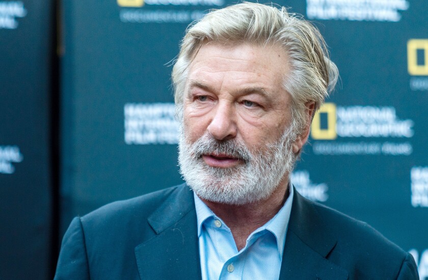 A man with gray hair and a full beard in a blue suit