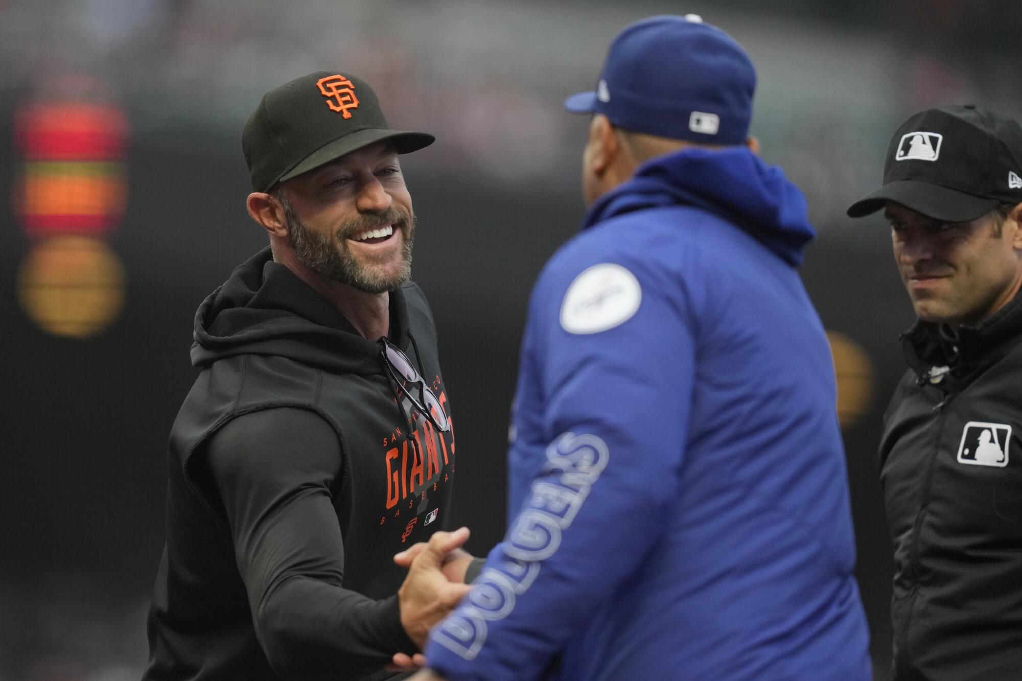 Giants manager Gabe Kapler greets Dodgers manager Dave Roberts before Monday's game in San Francisco.