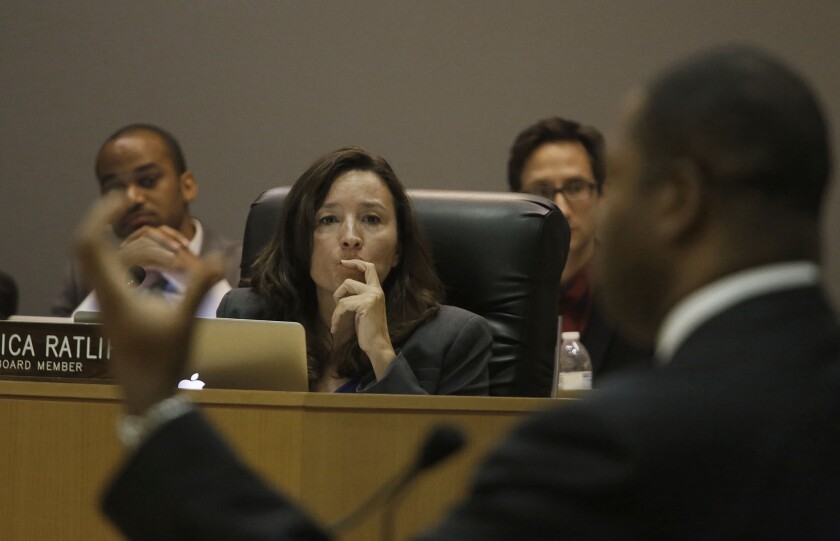 L.A. school board member Monica Ratliff listens as the LAUSD's chief information officer, Ron Chandler, right, speaks at an August board meeting.