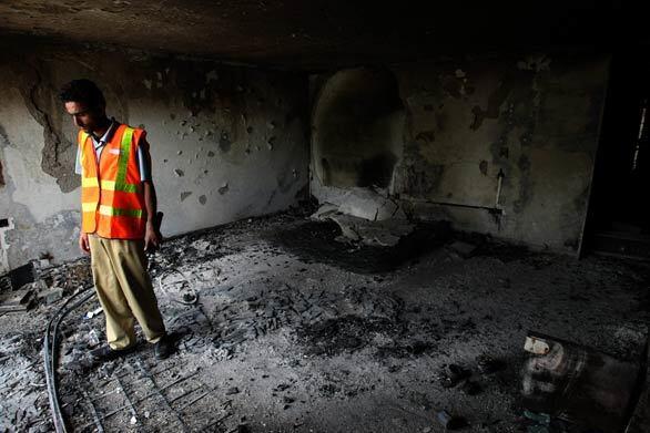 A member of a rescue team inspects a room at the Islamabad Marriott Hotel, which was hit by a devastating truck bomb on Saturday.