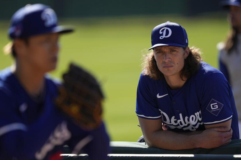 Los Angeles Dodgers pitcher Tyler Glasnow, right, watches as teammate Yoshinobu Yamamoto.