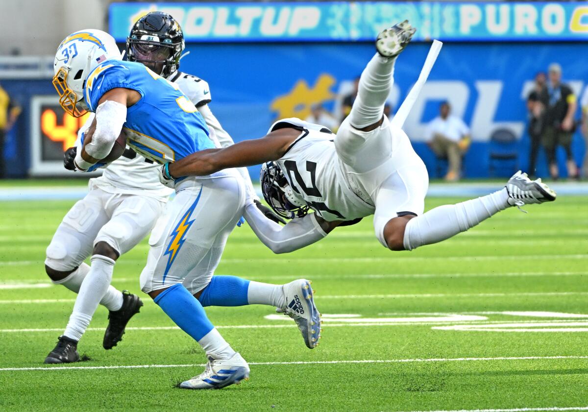 Chargers fullback Zander Horvath is brought down by Jaguars cornerback Tyson Campbell in the fourth quarter.