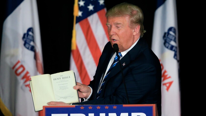 Republican presidential candidate Donald Trump with a bible at campaign stop in Iowa.